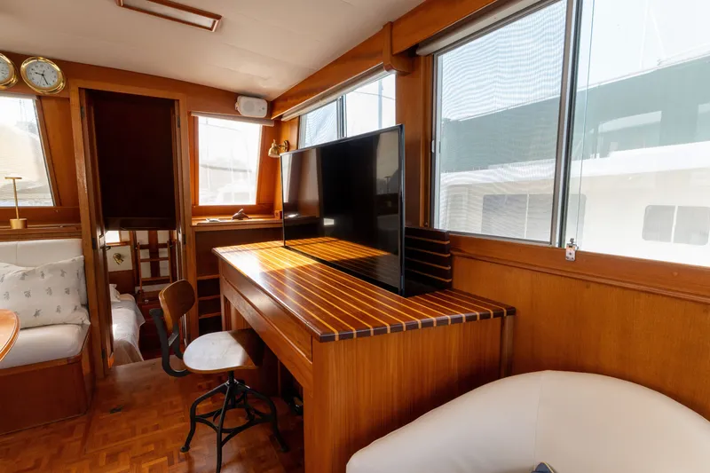 Slide: The Image of Interior of 1998 Grand Banks 46 Classic yacht with wooden furnishings and large windows. - 13