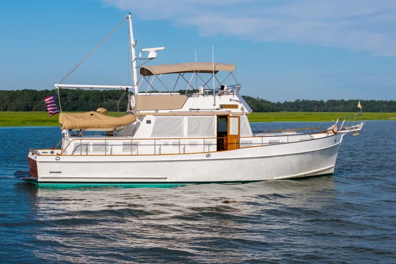 Slide: The Image of Grand Banks 46 Classic yacht from 1998 on calm water, with clear skies. - 101