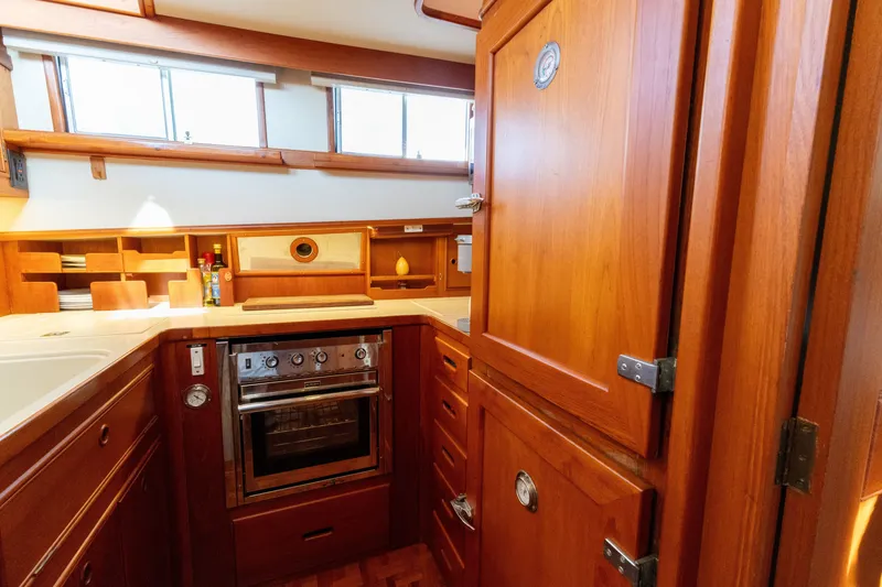 Slide: The Image of Wooden galley interior of 1998 Grand Banks 46 Classic yacht with stove and storage. - 29