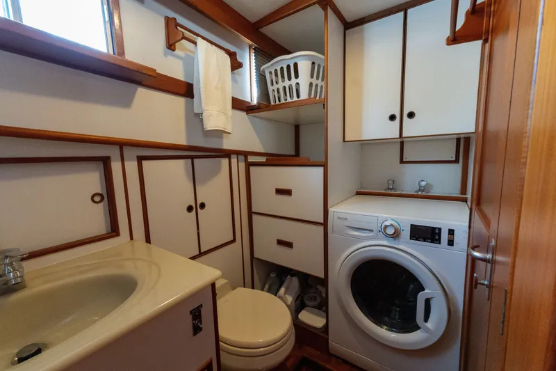 Slide: The Image of Laundry area in 1998 Grand Banks 46 Classic yacht with washer, sink, and storage cabinets. - 38