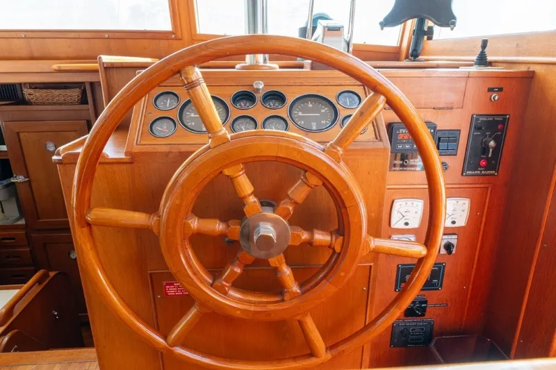 Slide: The Image of Wooden helm of 1998 Grand Banks 46 Classic yacht with gauges and controls. - 23