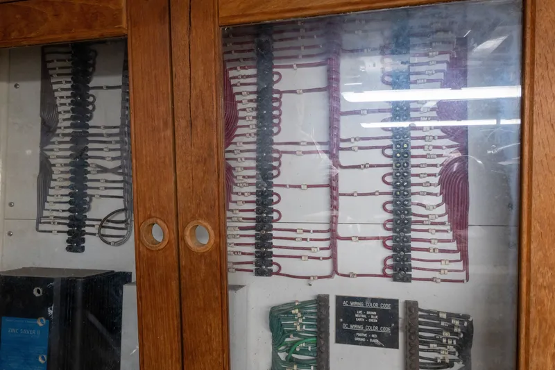 Slide: The Image of Electrical panel inside a 1998 Grand Banks 46 Classic boat, showcasing wiring and color codes. - 59