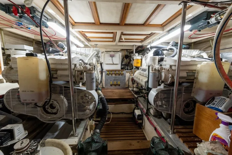 Slide: The Image of Engine room of 1998 Grand Banks 46 Classic yacht, showcasing dual engines and mechanical components. - 61