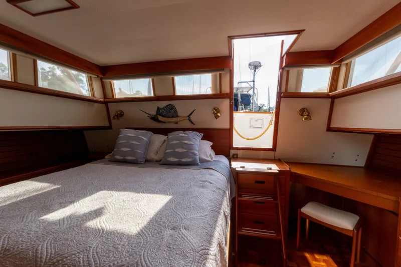 Slide: The Image of Cozy bedroom in 1998 Grand Banks 46 Classic yacht with nautical decor and natural light. - 44