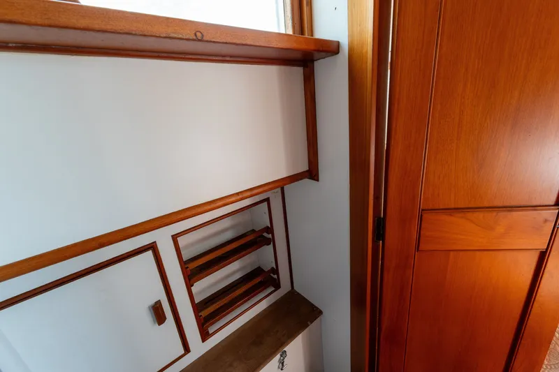 Slide: The Image of Interior of 1998 Grand Banks 46 Classic yacht with wooden cabinetry and shelving. - 49
