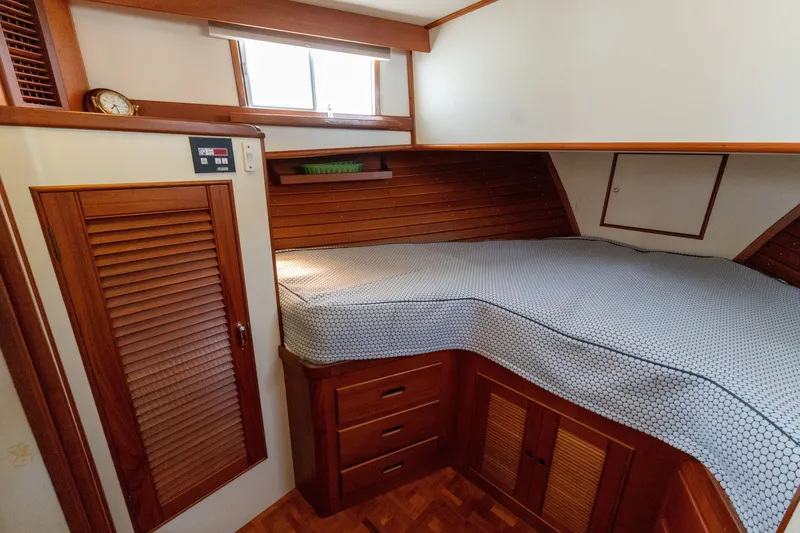 Slide: The Image of Cozy cabin interior of 1998 Grand Banks 46 Classic yacht with wooden furnishings and bed. - 35