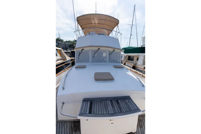 Slide: The Image of 1998 Grand Banks 46 Classic yacht docked, showcasing spacious deck and elegant design. - 87