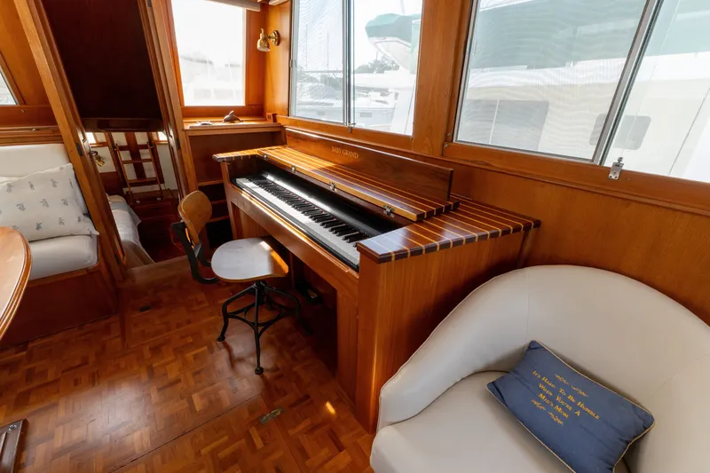 Slide: The Image of Luxurious 1998 Grand Banks 46 Classic yacht interior with piano and elegant seating. - 10
