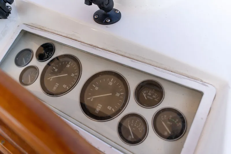 Slide: The Image of Instrument panel of a 1998 Grand Banks 46 Classic yacht, featuring various gauges. - 84