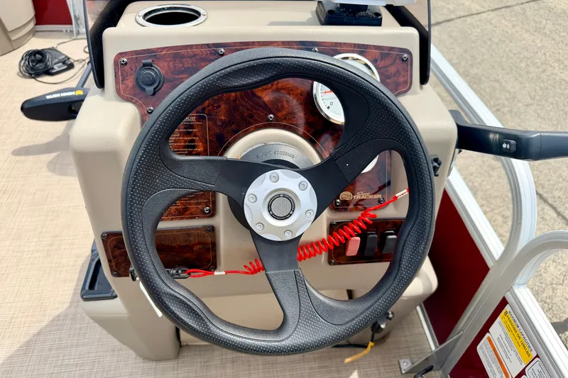 Slide: The Image of 2022 Sun Tracker Bass Buggy 18 DLX steering wheel and dashboard controls. - 40