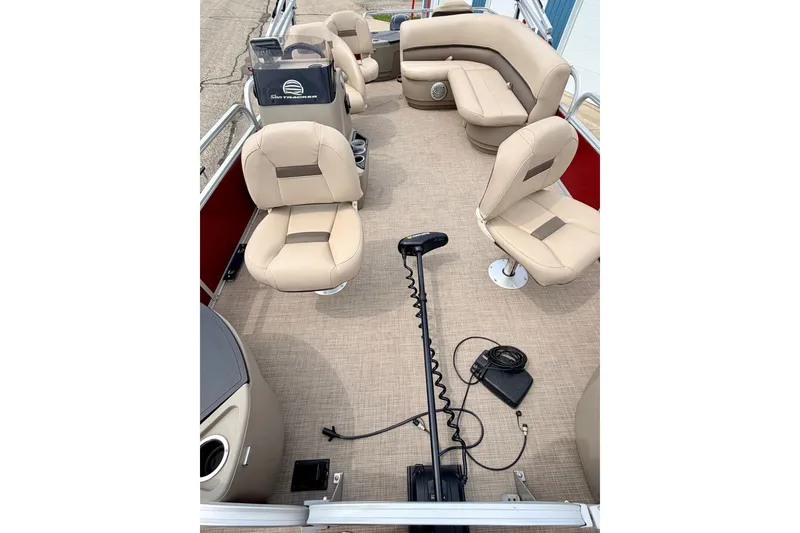 Slide: The Image of 2022 Sun Tracker Bass Buggy 18 DLX pontoon boat interior with beige seating and steering console. - 67