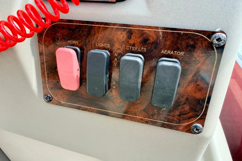 Slide: The Image of Control panel of 2022 Sun Tracker Bass Buggy 18 DLX with switches for horn, lights, and aerator. - 43