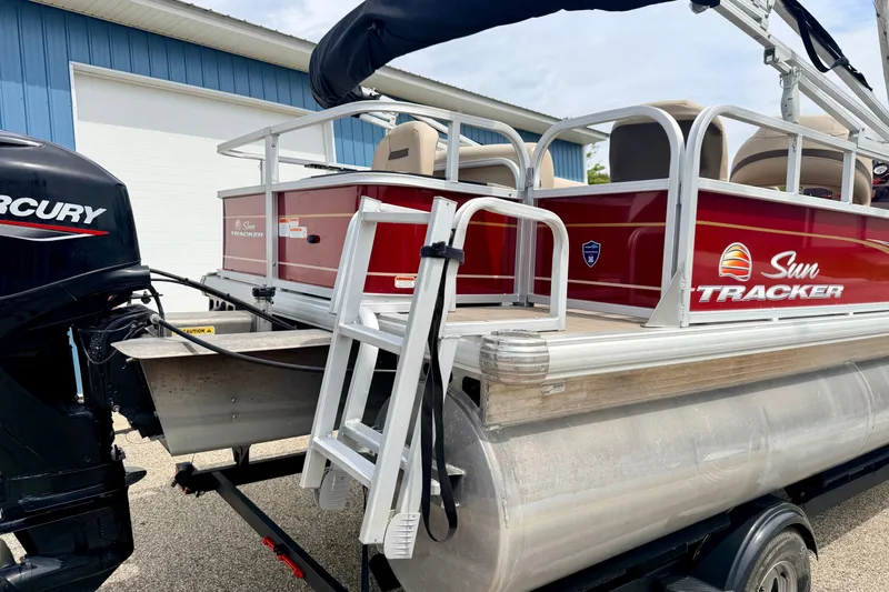 Slide: The Image of 2022 Sun Tracker Bass Buggy 18 DLX pontoon boat with Mercury engine and ladder. - 14