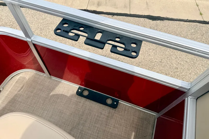 Slide: The Image of 2022 Sun Tracker Bass Buggy 18 DLX boat interior with red paneling and beige seating. - 31
