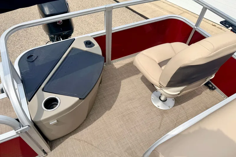 Slide: The Image of 2022 Sun Tracker Bass Buggy 18 DLX interior with beige seating and fishing station. - 23