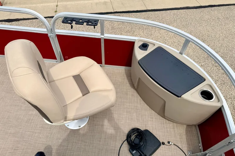 Slide: The Image of 2022 Sun Tracker Bass Buggy 18 DLX boat interior with beige seat and storage compartment. - 56