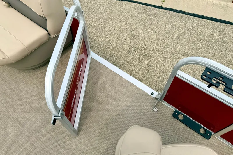 Slide: The Image of 2022 Sun Tracker Bass Buggy 18 DLX boat interior with open gate and beige seating. - 66