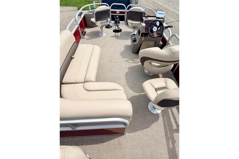 Slide: The Image of 2022 Sun Tracker Bass Buggy 18 DLX interior with beige seating and steering console. - 37