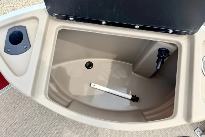 Slide: The Image of 2022 Sun Tracker Bass Buggy 18 DLX livewell compartment with open lid. - 59