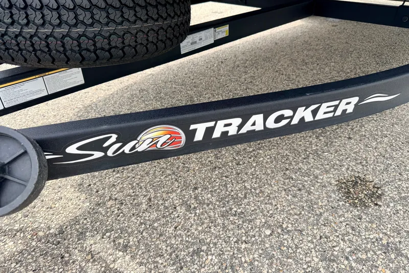 Slide: The Image of 2022 Sun Tracker Bass Buggy 18 DLX trailer with logo on pavement background. - 74