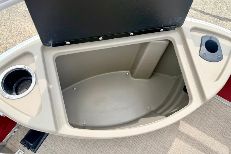 Slide: The Image of Open storage compartment on 2022 Sun Tracker Bass Buggy 18 DLX boat with cup holders. - 54