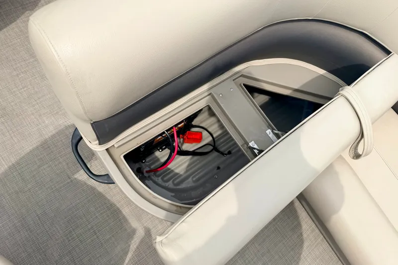 Slide: The Image of 2022 Sun Tracker Bass Buggy 18 DLX boat seat storage compartment with visible wiring. - 34