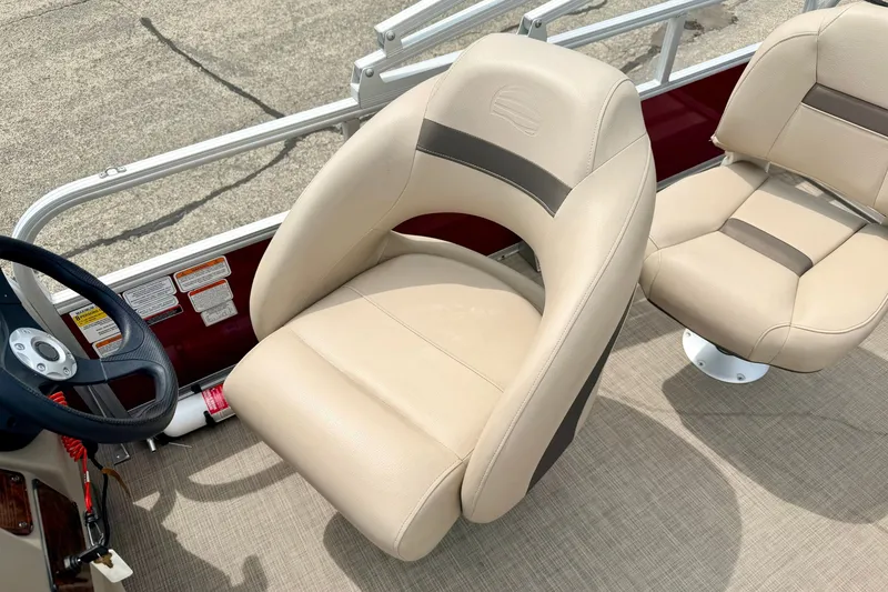 Slide: The Image of 2022 Sun Tracker Bass Buggy 18 DLX boat seats and steering wheel, beige upholstery. - 38
