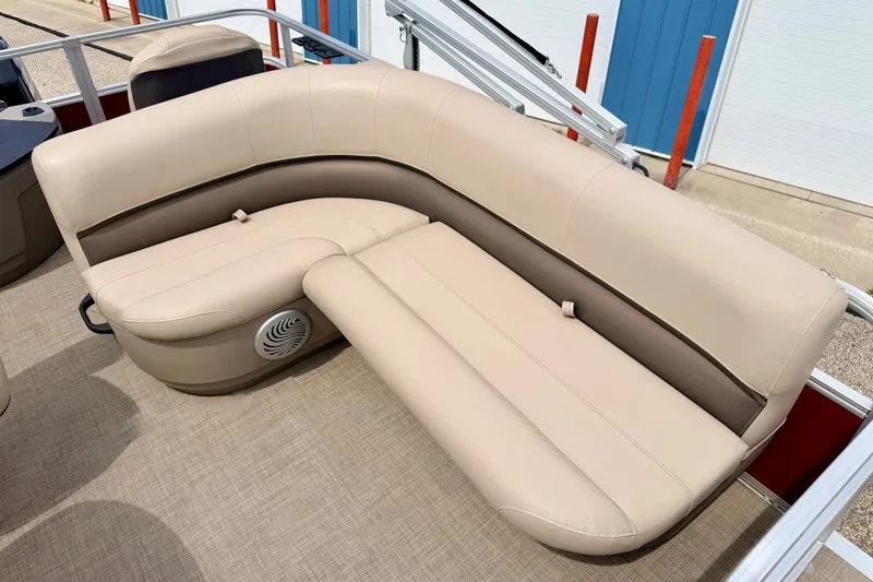 Slide: The Image of 2022 Sun Tracker Bass Buggy 18 DLX pontoon boat seating, beige upholstery, outdoor setting. - 32