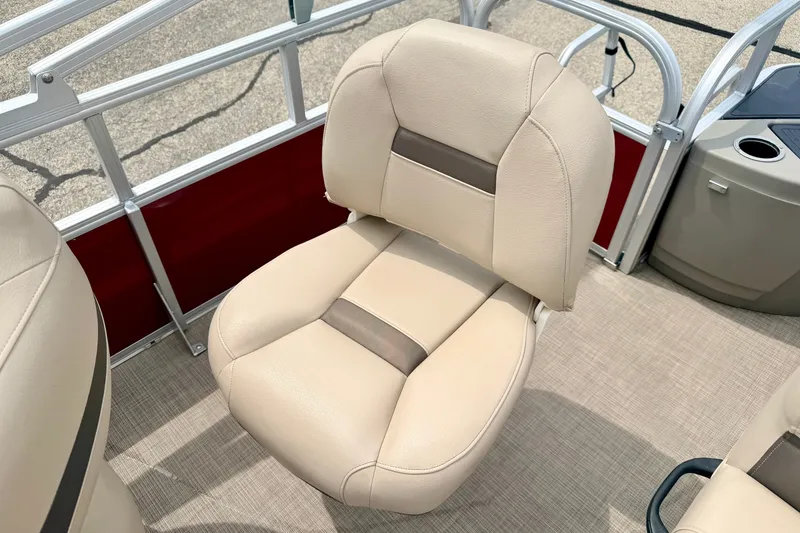 Slide: The Image of 2022 Sun Tracker Bass Buggy 18 DLX boat seat, beige upholstery, red paneling, and cup holder. - 29