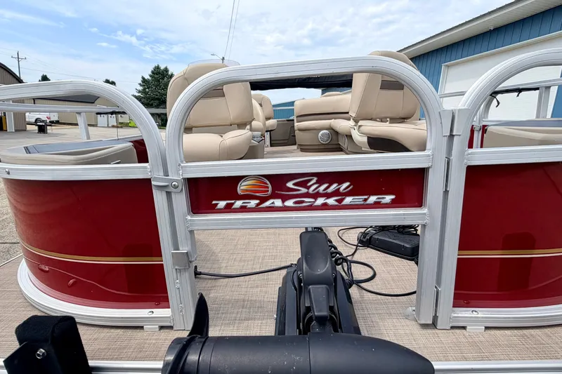 Slide: The Image of 2022 Sun Tracker Bass Buggy 18 DLX pontoon boat with beige seating and red exterior. - 68