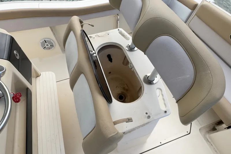 Slide: The Image of 2014 Scout 225 XSF boat interior with seating and storage compartment. - 18