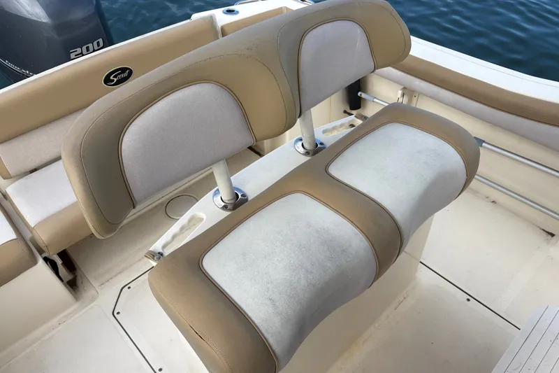 Slide: The Image of 2014 Scout 225 XSF boat seating with beige and white upholstery. - 16
