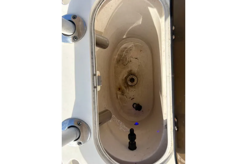 Slide: The Image of Livewell interior of 2014 Scout 225 XSF boat, showing drainage and fittings. - 33