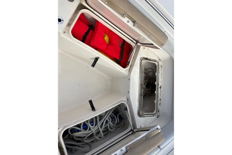 Slide: The Image of Storage compartments on a 2014 Scout 225 XSF boat with life jackets and ropes. - 30