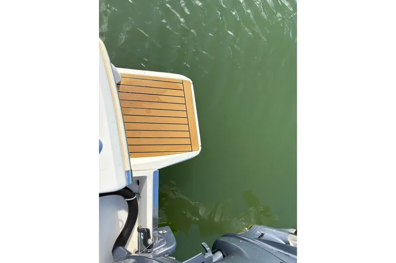 Slide: The Image of 2014 Scout 225 XSF boat swim platform over green water. - 9