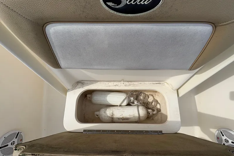 Slide: The Image of Storage compartment on a 2014 Scout 225 XSF boat with fenders and ropes. - 28