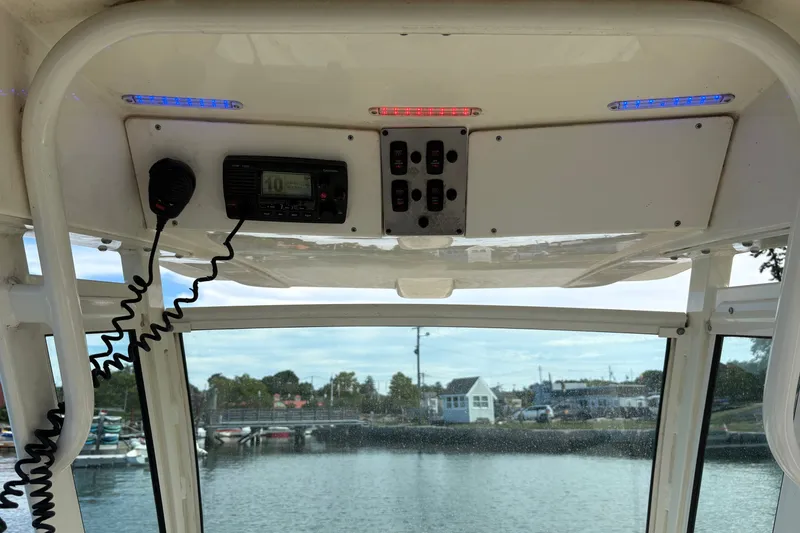 Slide: The Image of Interior view of a 2014 Scout 225 XSF boat with control panel and radio. - 23