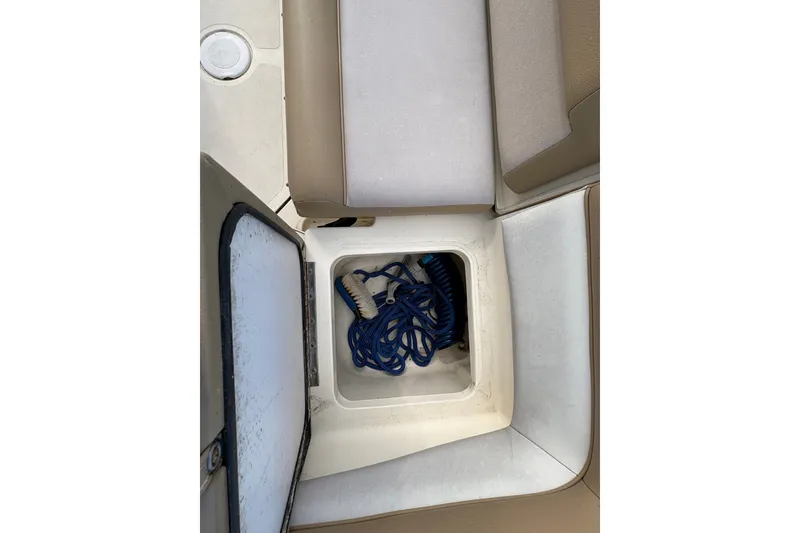 Slide: The Image of Storage compartment on a 2014 Scout 225 XSF boat with coiled blue rope. - 13