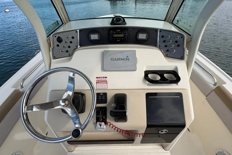 Slide: The Image of 2014 Scout 225 XSF boat dashboard with Garmin navigation system and steering wheel. - 21