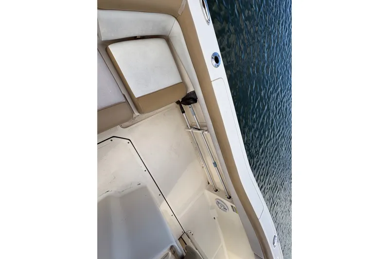 Slide: The Image of Interior view of a 2014 Scout 225 XSF boat with tan and white seating. - 12