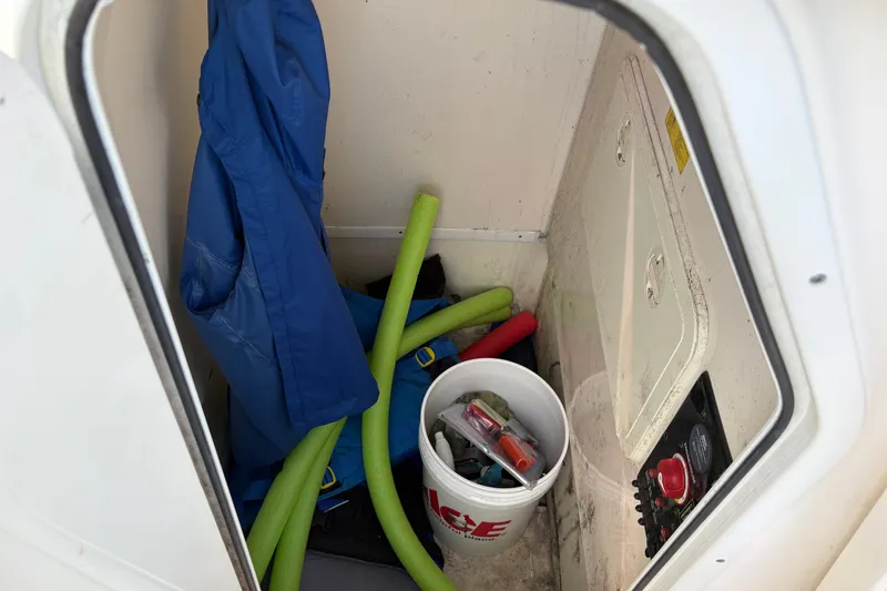 Slide: The Image of Storage compartment of 2014 Scout 225 XSF boat with gear and supplies. - 32