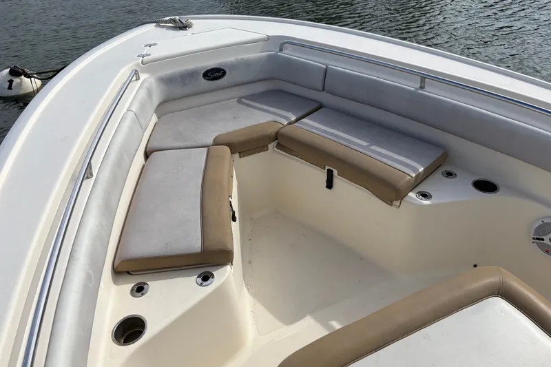 Slide: The Image of 2014 Scout 225 XSF boat interior with cushioned seating and cup holders. - 24
