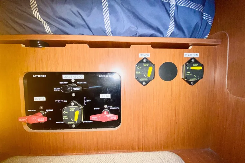 Slide: The Image of Control panel of a 2016 Beneteau Oceanis 41 sailboat, featuring battery switches and breakers. - 53
