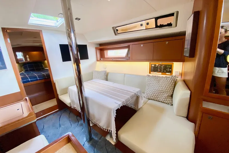 Slide: The Image of Interior of 2016 Beneteau Oceanis 41 yacht with cozy seating and dining area. - 42