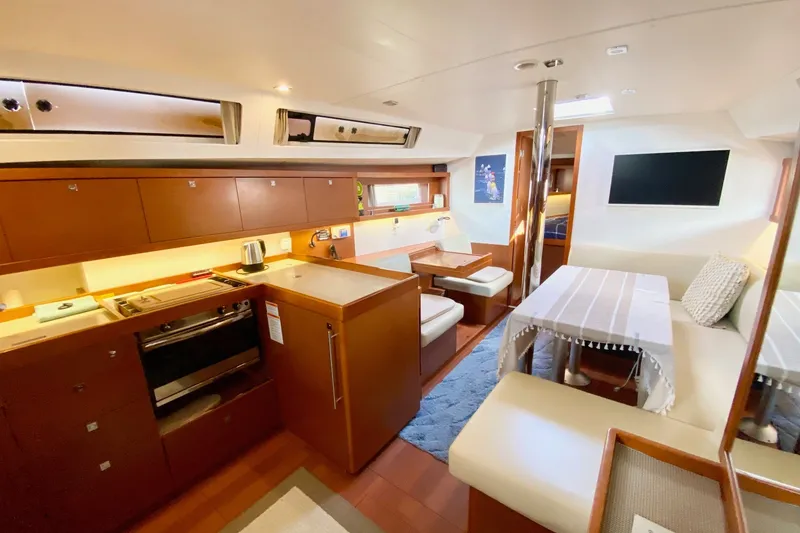 Slide: The Image of Interior of 2016 Beneteau Oceanis 41 yacht with modern kitchen and dining area. - 30