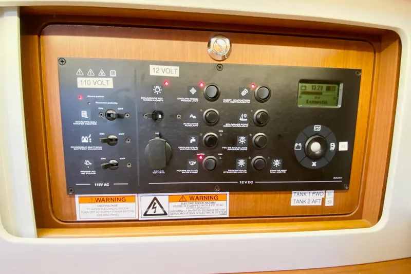 Slide: The Image of Control panel of a 2016 Beneteau Oceanis 41 sailboat, featuring voltage and system controls. - 54