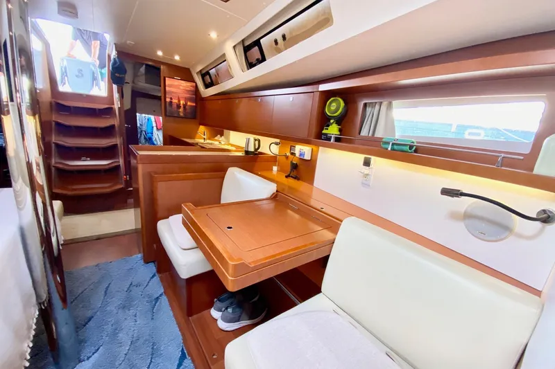 Slide: The Image of Interior of 2016 Beneteau Oceanis 41 yacht with wooden furnishings and seating area. - 41