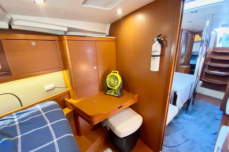 Slide: The Image of Interior of 2016 Beneteau Oceanis 41 yacht with wooden cabinetry and compact seating area. - 44