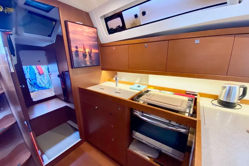 Slide: The Image of Interior of 2016 Beneteau Oceanis 41 yacht kitchen with modern amenities. - 35