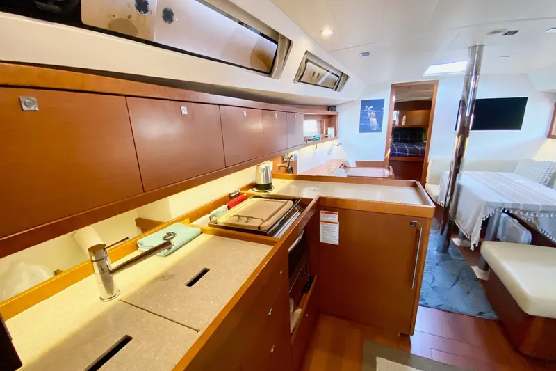 Slide: The Image of Interior of 2016 Beneteau Oceanis 41 yacht, featuring modern kitchen and cozy living area. - 33